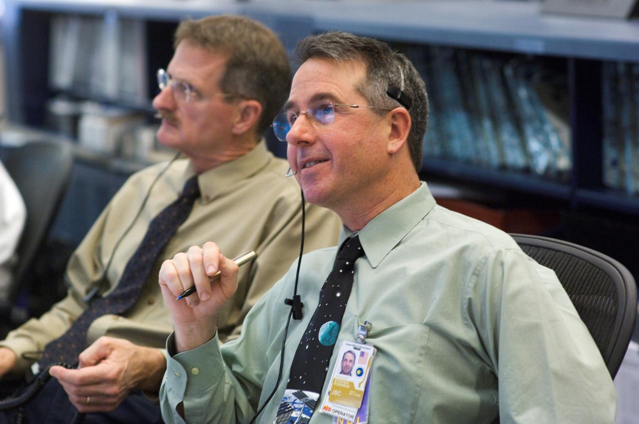 JSC2006-E-54451 (17 Dec. 2006) --- Astronauts Stephen K. Robinson and Joseph R. Tanner, spacecraft communicators (CAPCOM), communicate with the STS-116 crew and its spacewalkers participating in an unprecedented fourth session of extravehicular activity on the same shuttle mission. The two spacewalk veterans are seated at the CAPCOM console in the space station flight control room (FCR-1) in the Johnson Space Center's Mission Control Center.