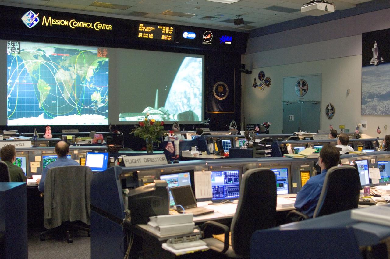 JSC2006-E-54711 (21 Dec. 2006) --- Overall view of the Shuttle Flight Control Room in the Johnson Space Center's Mission Control Center during the final deployment of some small satellites from Space Shuttle Discovery's cargo bay. On a screen in the front of the control room, a Department of Defense pico-satellite known as Atmospheric Neutral Density Experiment (ANDE) is released from the shuttle's payload bay by STS-116 crewmembers and viewed via live television on the ground.