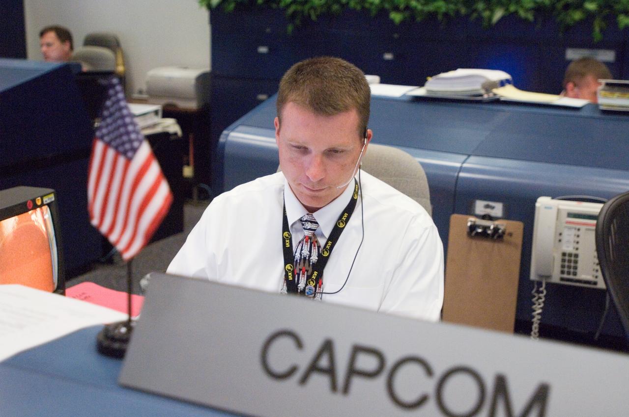 JSC2007-E-28281 (8 June 2007) --- In the space shuttle flight control room of Johnson Space Center's Mission Control Center (MCC), astronaut Terry W. Virts Jr., spacecraft communicator (CAPCOM), monitors weather data and launch countdown activities a few hundred miles away in Florida, site of Space Shuttle Atlantis' scheduled STS-117 launch. Liftoff occurred at 7:38 p.m. (EDT) on June 8, 2007 from launch pad 39A at Kennedy Space Center.
