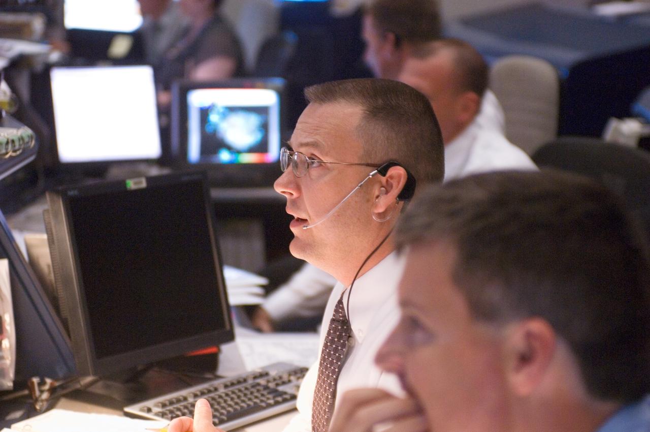 JSC2007-E-28288 (8 June 2007) --- In the space shuttle flight control room of Johnson Space Center's Mission Control Center (MCC), flight directors Norm Knight and Steve Stich (foreground) monitor launch countdown activities a few hundred miles away in Florida, site of Space Shuttle Atlantis' scheduled STS-117 launch. Liftoff occurred at 7:38 p.m. (EDT) on June 8, 2007 from launch pad 39A at Kennedy Space Center.
