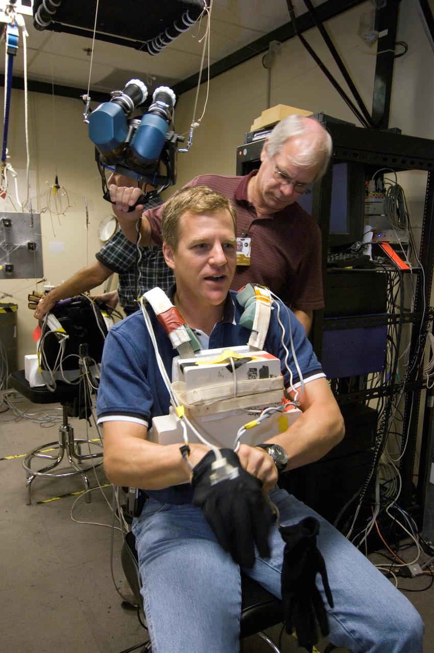 JSC2007-E-41534 (9 Aug. 2007) --- Astronaut Scott E. Parazynski, STS-120 mission specialist, prepares to use virtual reality hardware in the Space Vehicle Mockup Facility at Johnson Space Center to rehearse some of his duties on the upcoming mission to the International Space Station. This type of virtual reality training allows the astronauts to wear special gloves and other gear while looking at computer displays simulating actual movements around the various locations on the station hardware with which they will be working. David J. Homan assisted Parazynski.