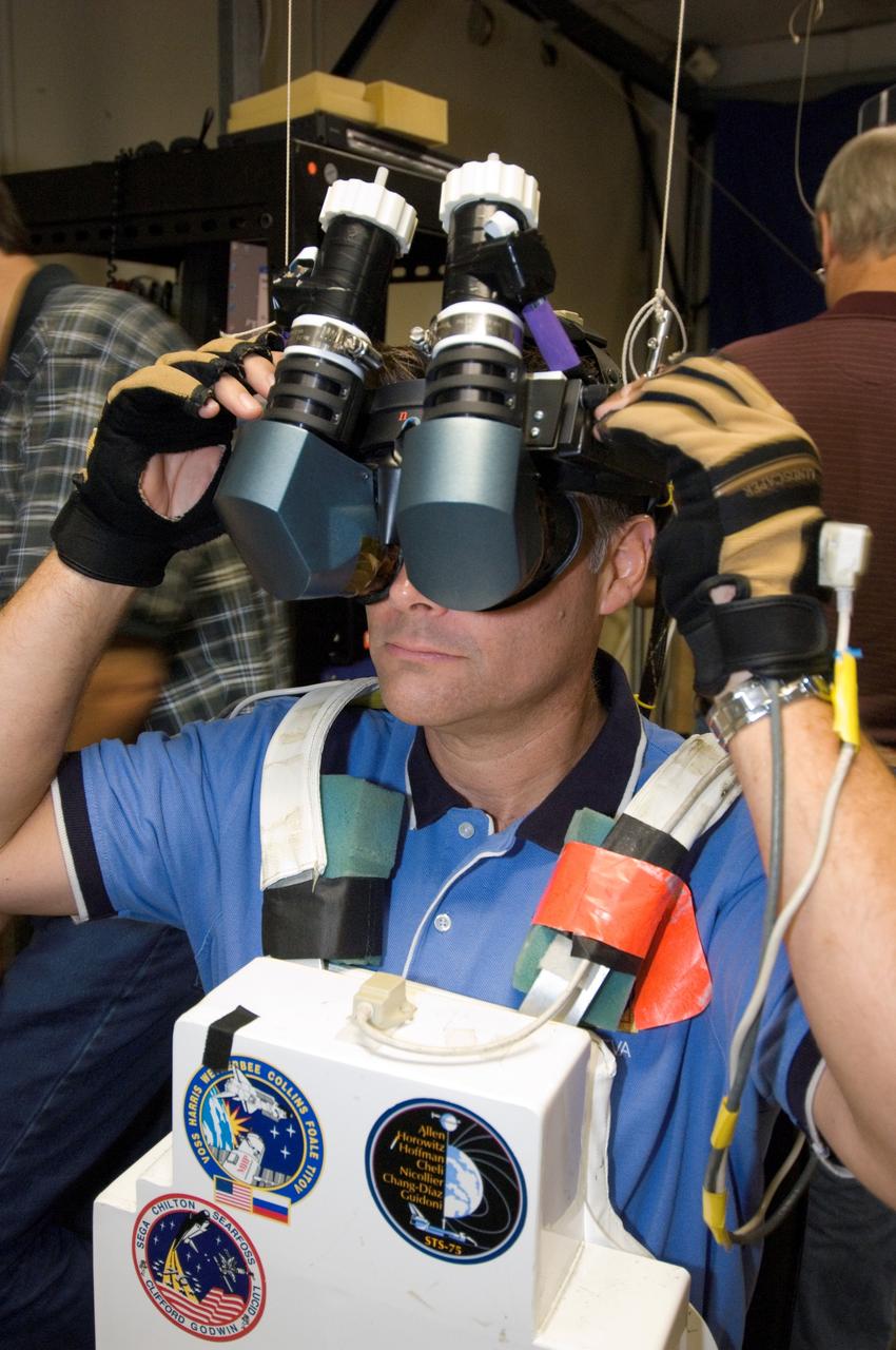JSC2007-E-41535 (9 Aug. 2007) --- Astronaut Douglas H. Wheelock, STS-120 mission specialist, uses virtual reality hardware in the Space Vehicle Mockup Facility at Johnson Space Center to rehearse some of his duties on the upcoming mission to the International Space Station. This type of virtual reality training allows the astronauts to wear special gloves and other gear while looking at computer displays simulating actual movements around the various locations on the station hardware with which they will be working.