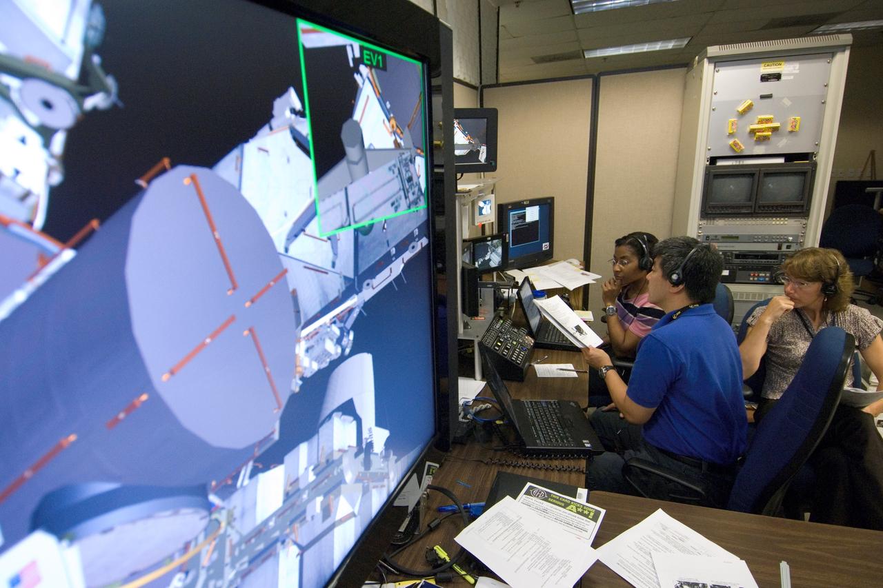 JSC2007-E-41538 (9 Aug. 2007) --- Astronauts Stephanie Wilson, STS-120 mission specialist; Sandra Magnus, Expedition 17 flight engineer; and Dan Tani, Expedition 16 flight engineer, use the virtual reality lab at Johnson Space Center to train for their duties aboard the space shuttle and space station. This type of computer interface, paired with virtual reality training hardware and software, helps to prepare the entire team for dealing with space station elements. A computer display is visible in the foreground.