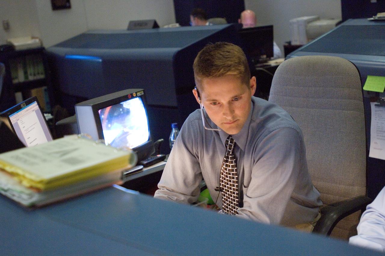 JSC2007-E-41734 (8 Aug. 2007) --- At the CAPCOM console in the space shuttle flight operations control room of Houston's Mission Control Center, astronaut James P. (Jim) Dutton Jr.,  STS-118 spacecraft communicator, monitors pre-launch activities of the Space Shuttle Endeavour, several hundred miles away in Florida. Dutton was assigned to watch weather at  geographic areas  involved in the launch.
