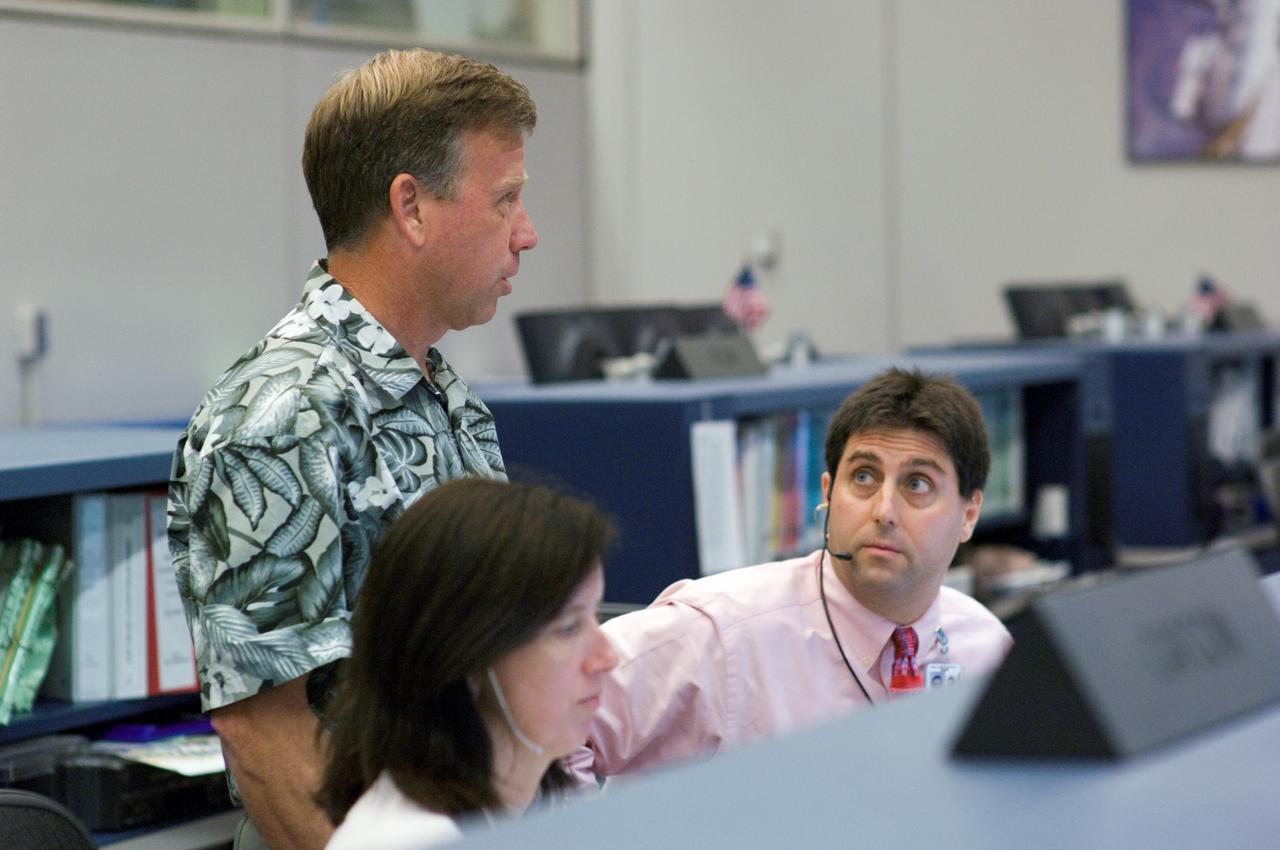 JSC2007-E-42074 (10 Aug. 2007) --- In the space station flight operations control room of Houston's Mission Control Center, astronaut Shannon Walker, ISS spacecraft communicator (CAPCOM), and ISS lead flight director Joel Montalbano (right) keep up with in-space operations of the Space Shuttle Endeavour and the International Space Station. The two craft accomplished a link-up that allows the start of over a week's joint activities to perform work on the orbiting outpost. Astronaut Steven W. (Steve) Lindsey, chief of JSC's astronaut office,  joins them.