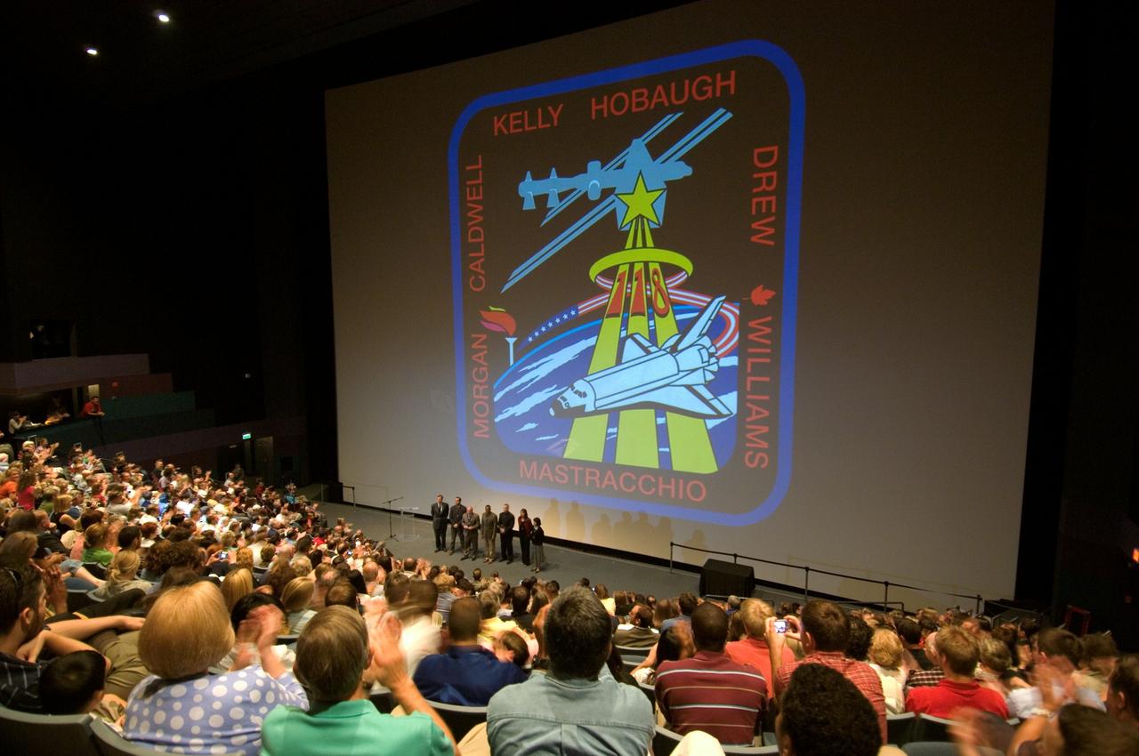 Photo taken during the STS-118 Crew Debriefing and Awards Presentation in Space Center Houston, Grumman Theatre. View is taken from behind audience of the large screen at the front of the theatre during the presentation.