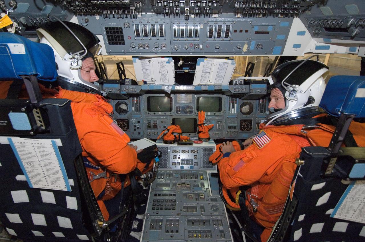 JSC2007-E-48205 (28 Sept. 2007) --- While seated at the commander's and pilot's stations, astronauts Mark E. Kelly (left) and Kenneth T. Ham, STS-124 commander and pilot, respectively, participate in a training session in the crew compartment trainer (CCT-2) in the Space Vehicle Mockup Facility at Johnson Space Center. Kelly and Ham are wearing training versions of their shuttle launch and entry suits.