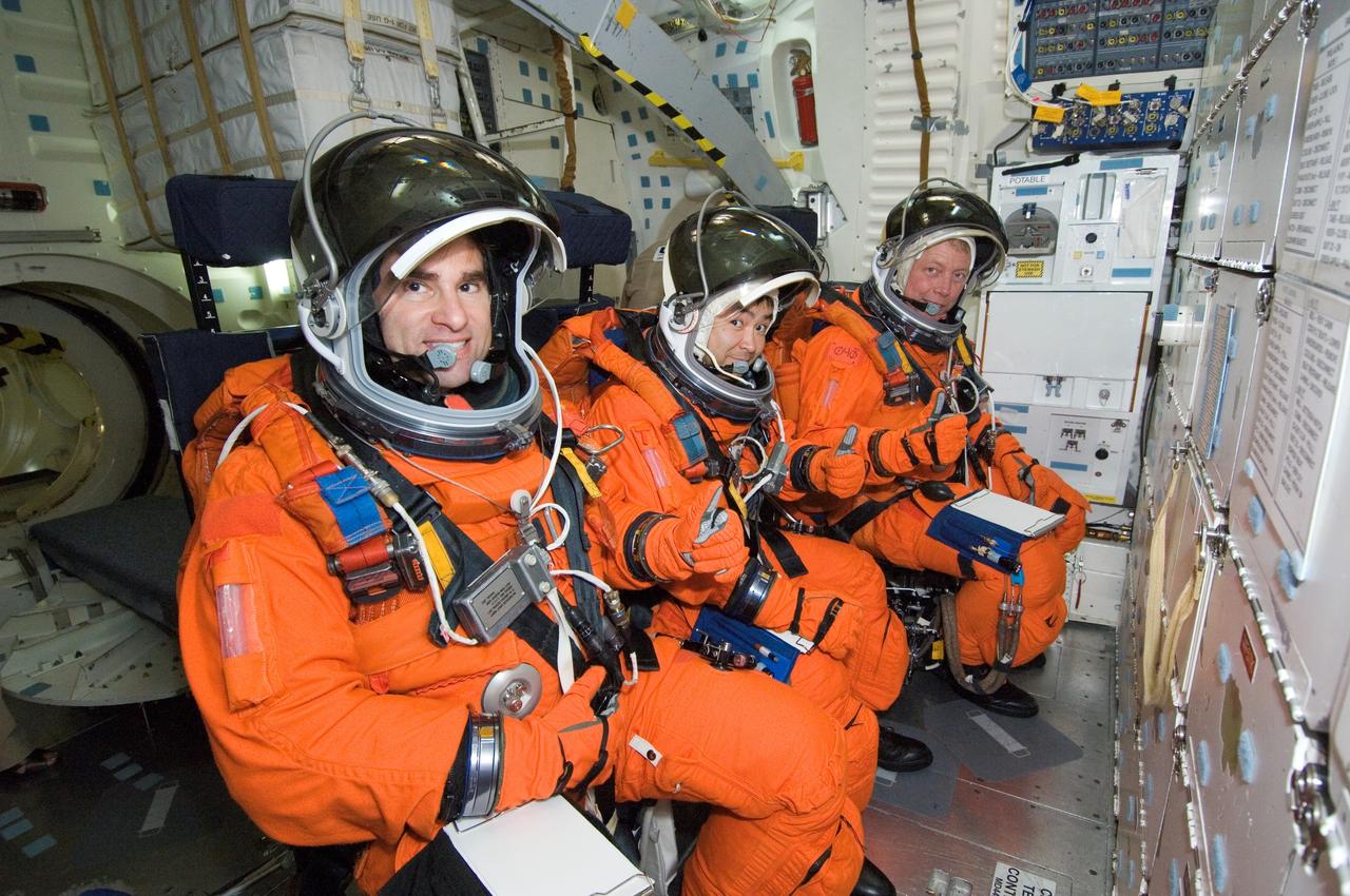 JSC2007-E-48215 (28 Sept. 2007) --- Astronauts Gregory E. Chamitoff (left), Expedition 17 flight engineer; Japan Aerospace Exploration Agency's (JAXA) Akihiko Hoshide and Michael E. Fossum, both STS-124 mission specialists, participate in a training session in one of the full-scale trainers in the Space Vehicle Mockup Facility at Johnson Space Center. Attired in training versions of their shuttle launch and entry suits, the three are seated on the middeck for a post insertion training session.