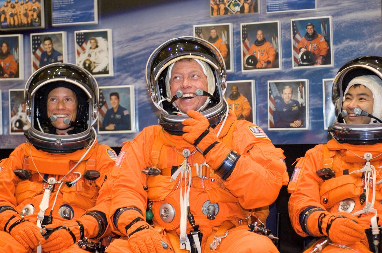 JSC2007-E-48226 (28 Sept. 2007) --- Attired in training versions of their shuttle launch and entry suits, astronauts Karen L. Nyberg (left), Michael E. Fossum and Japan Aerospace Exploration Agency's (JAXA) Akihiko Hoshide, all STS-124 mission specialists, await the start of a training session in the Space Vehicle Mockup Facility at Johnson Space Center.