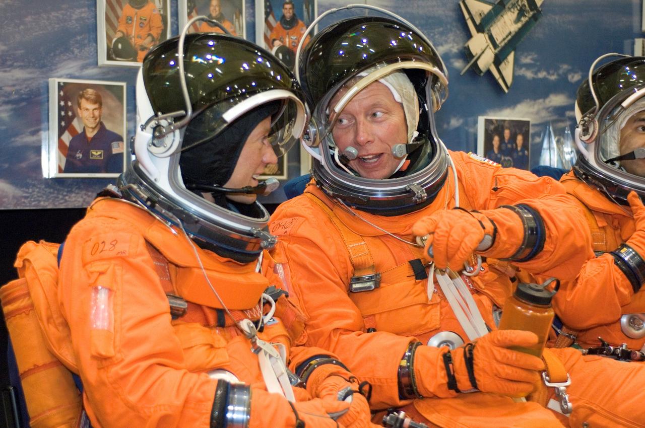 JSC2007-E-48230 (28 Sept. 2007) --- Attired in training versions of their shuttle launch and entry suits, astronauts Karen L. Nyberg (left) and Michael E. Fossum, both STS-124 mission specialists, exchange thoughts as they await the start of a training session in the Space Vehicle Mockup Facility at Johnson Space Center.
