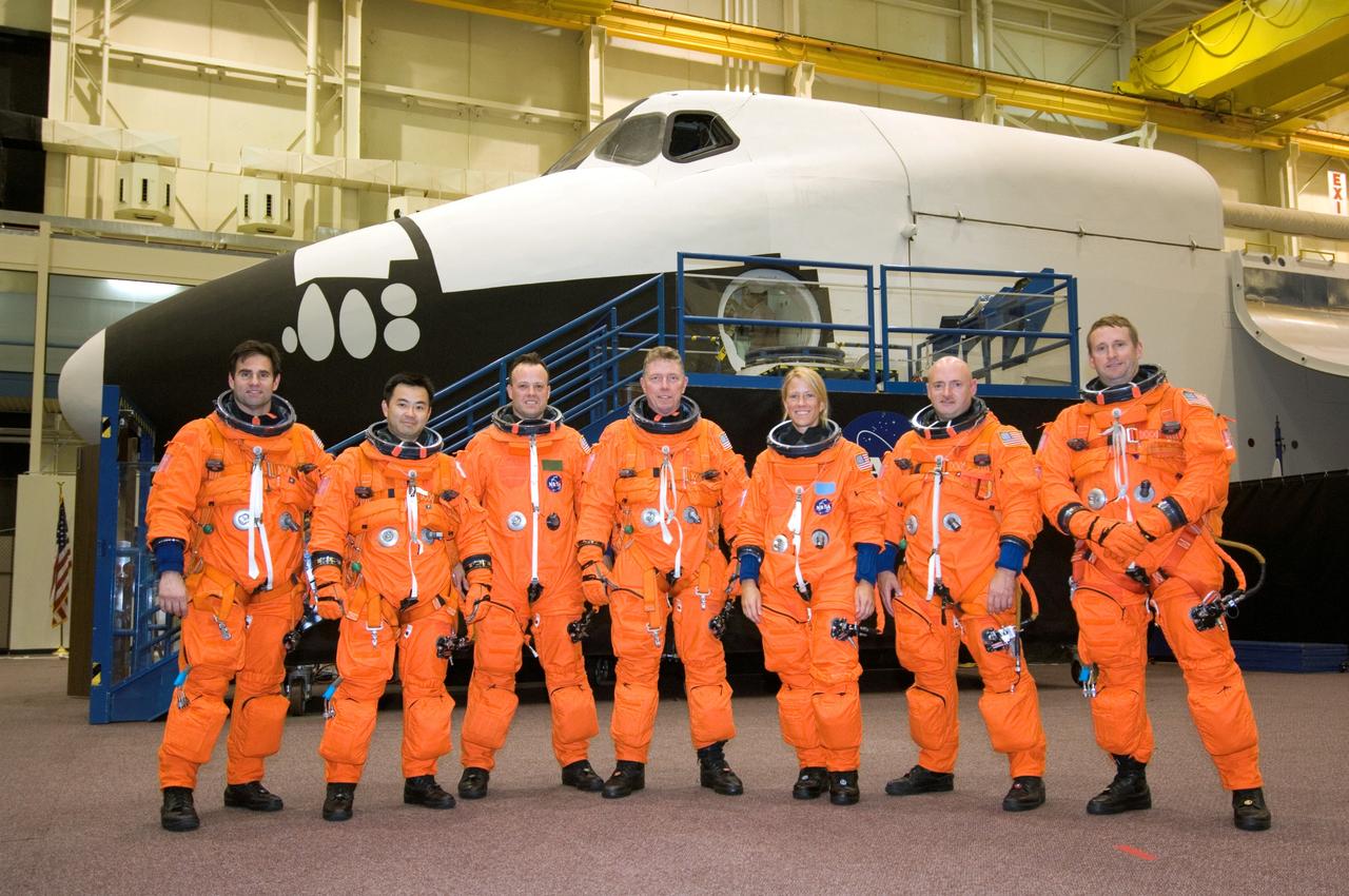 JSC2007-E-48272 (28 Sept. 2007) --- Astronauts Gregory E. Chamitoff (left), Expedition 17 flight engineer; Japan Aerospace Exploration Agency's (JAXA) Akihiko Hoshide, Ronald J. Garan, Michael E. Fossum, Karen L. Nyberg, all STS-124 mission specialists; Mark E. Kelly and Kenneth T. Ham, STS-124 commander and pilot, respectively, pose for a group photo prior to a training session in the Space Vehicle Mockup Facility at Johnson Space Center. The crewmembers are wearing training versions of their shuttle launch and entry suits.