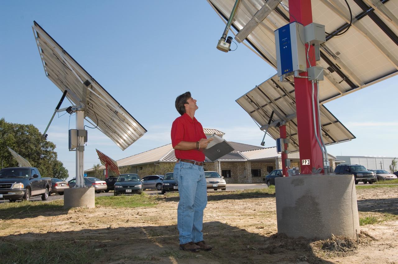 Solar panel and wind farm at the JSC Child Care Center. View of Jerry Rowlands, Energy Management and Control System manager for CSC.