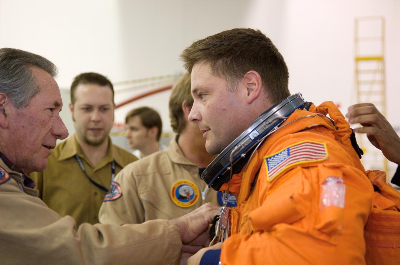JSC2007-E-06416 (31 Jan. 2007) --- Astronaut Douglas H. Wheelock (right), STS-120 mission specialist, dons a training version of his shuttle launch and entry suit in preparation for a water survival training session in the Neutral Buoyancy Laboratory (NBL) near Johnson Space Center. United Space Alliance (USA) suit technician Jim Cheatham assisted Wheelock.