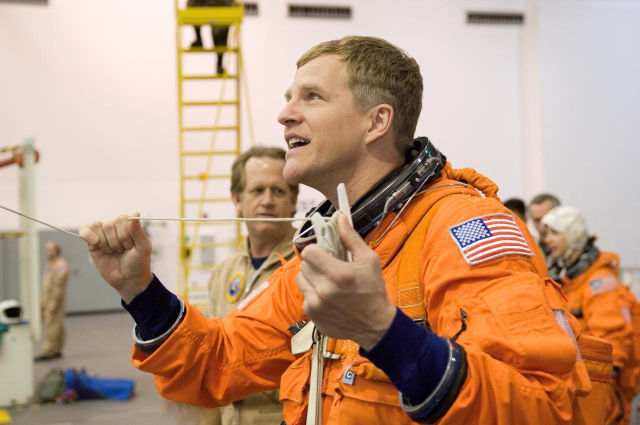 JSC2007-E-06436 (31 Jan. 2007) --- Astronaut Scott E. Parazynski, STS-120 mission specialist, attired in a training version of his shuttle launch and entry suit, works with a pulley during a water survival training session in the Neutral Buoyancy Laboratory (NBL) near Johnson Space Center.