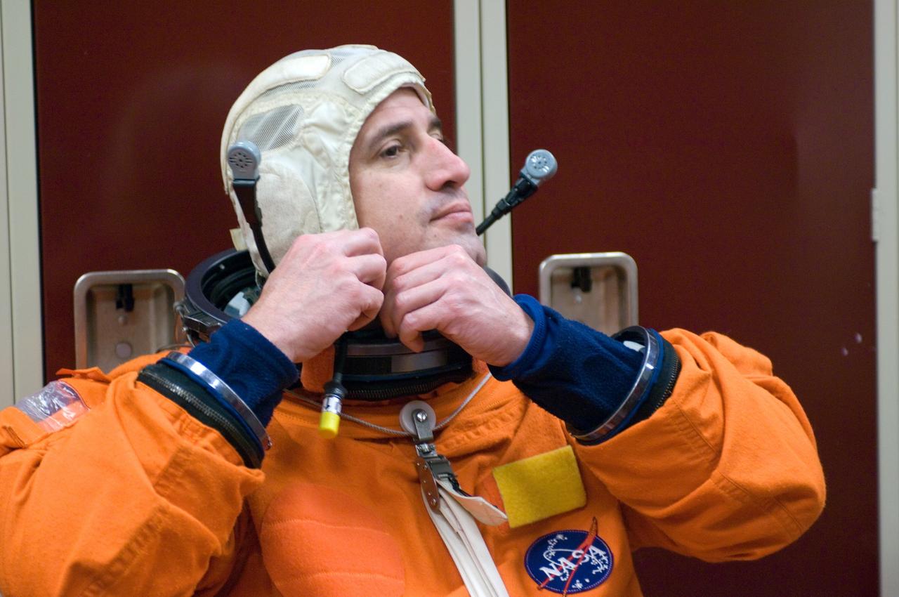 JSC2007-E-08808 (7 Feb. 2007) --- Astronaut George D. Zamka, STS-120 pilot, dons a training version of his shuttle launch and entry suit, in preparation for a post insertion/de-orbit training session in one of the full-scale trainers (out of frame) in the Space Vehicle Mockup Facility at Johnson Space Center.