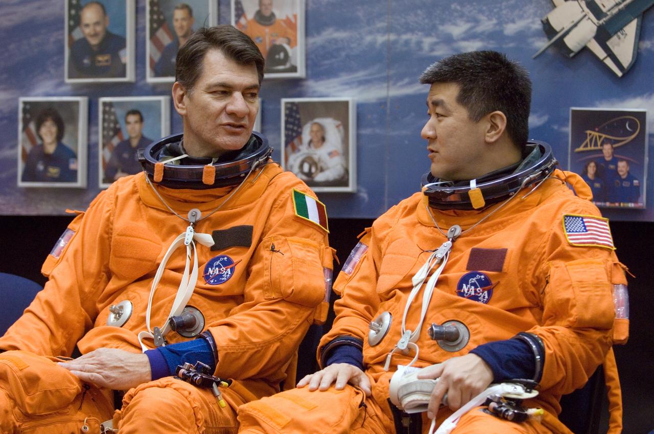 JSC2007-E-08815 (7 Feb. 2007) --- European Space Agency (ESA) astronaut Paolo Nespoli (left), STS-120 mission specialist, and astronaut Daniel M. Tani, Expedition 16 flight engineer, converse as they await the start of a post insertion/de-orbit training session in one of the full-scale trainers (out of frame) in the Space Vehicle Mockup Facility at Johnson Space Center. Nespoli and Tani are wearing training versions of their shuttle launch and entry suit. Tani will join Expedition 16 as flight engineer after launching to the International Space Station aboard Atlantis on mission STS-120 and is scheduled to return home aboard Discovery on mission STS-122.