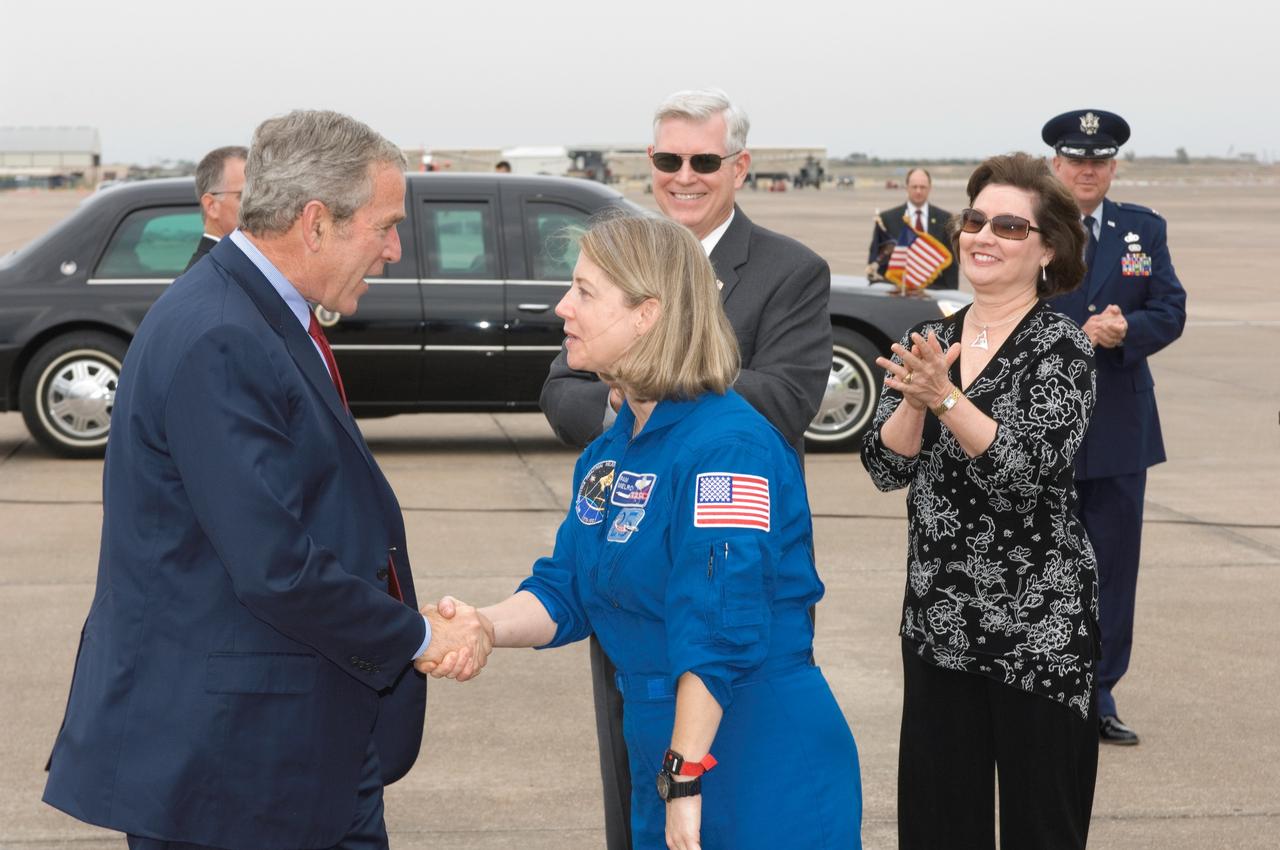 JSC2007-E-097963 (8 Nov. 2007) ---- The crew of the STS-120 mission received a special greeting upon their return home to Houston Thursday, Nov. 8, following the landing of space shuttle Discovery in Florida on Wednesday, Nov. 7. President George W. Bush greeted STS-120 commander Pam Melroy (pictured).  He also exchanged greetings with the other members of the crew (out of frame) -- pilot George Zamka and mission specialists Scott Parazynski, Stephanie Wilson, Doug Wheelock, Paolo Nespoli and Clay Anderson at Houston's Ellington Field.  JSC Director Mike Coats applauds in the background.
