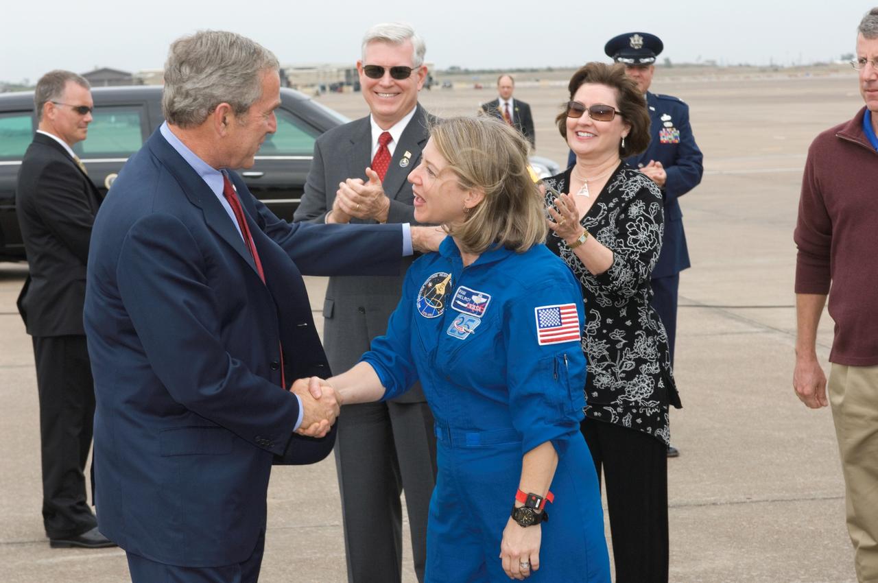 JSC2007-E-097964 (8 Nov. 2007) ---- The crew of the STS-120 mission received a special greeting upon their return home to Houston Thursday, Nov. 8, following the landing of space shuttle Discovery in Florida on Wednesday, Nov. 7. President George W. Bush greeted STS-120 commander Pam Melroy (pictured).  He also exchanged greetings with the other members of the crew (out of frame) -- pilot George Zamka and mission specialists Scott Parazynski, Stephanie Wilson, Doug Wheelock, Paolo Nespoli and Clay Anderson at Houston's Ellington Field.  JSC Director Mike Coats applauds in the background.