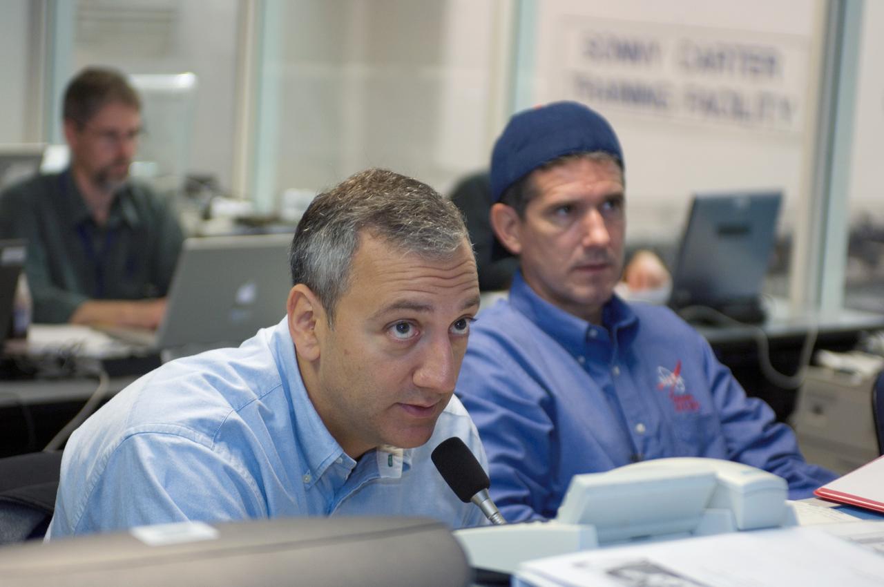 JSC2007-E-113505 (17 Dec. 2007) --- Astronauts Michael J. Massimino (left) and Michael T. Good, STS-125 mission specialists, participate in a training session at consoles in the simulation control area in the Neutral Buoyancy Laboratory (NBL) at the Sonny Carter Training Facility (SCTF) near Johnson Space Center (JSC).