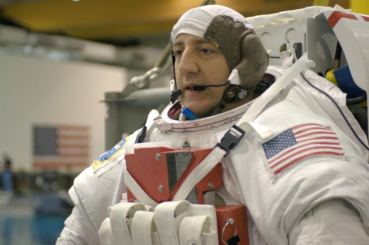 JSC2007-E-113604 (18 Dec. 2007) --- Astronaut Michael J. Massimino, STS-125 mission specialist, attired in a training version of the Extravehicular Mobility Unit (EMU) spacesuit, awaits the start of a training session in the waters of the Neutral Buoyancy Laboratory (NBL) near Johnson Space Center.