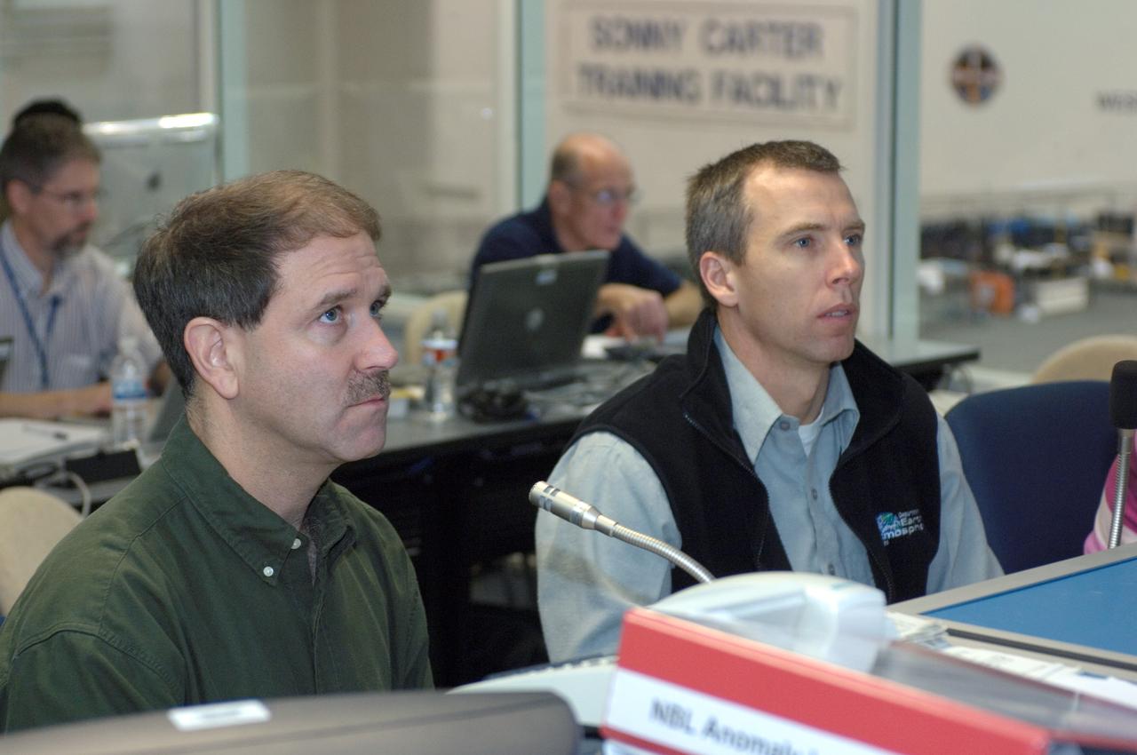 JSC2007-E-113616 (18 Dec. 2007) --- Astronauts John M. Grunsfeld (left) and Andrew J. Feustel, both STS-125 mission specialists, participate in a training session at consoles in the simulation control area in the Neutral Buoyancy Laboratory (NBL) at the Sonny Carter Training Facility (SCTF) near Johnson Space Center (JSC).