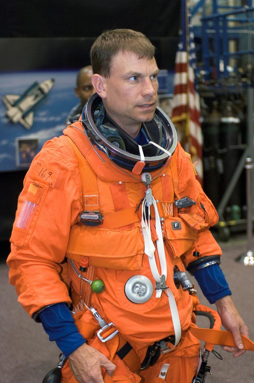 JSC2007-E-14469 (20 March 2007) --- Astronaut Stanley G. Love, STS-122 mission specialist, dons a training version of his shuttle launch and entry suit in preparation for a post insertion/de-orbit training session in one of the full-scale trainers (out of frame) in the Space Vehicle Mockup Facility at Johnson Space Center.