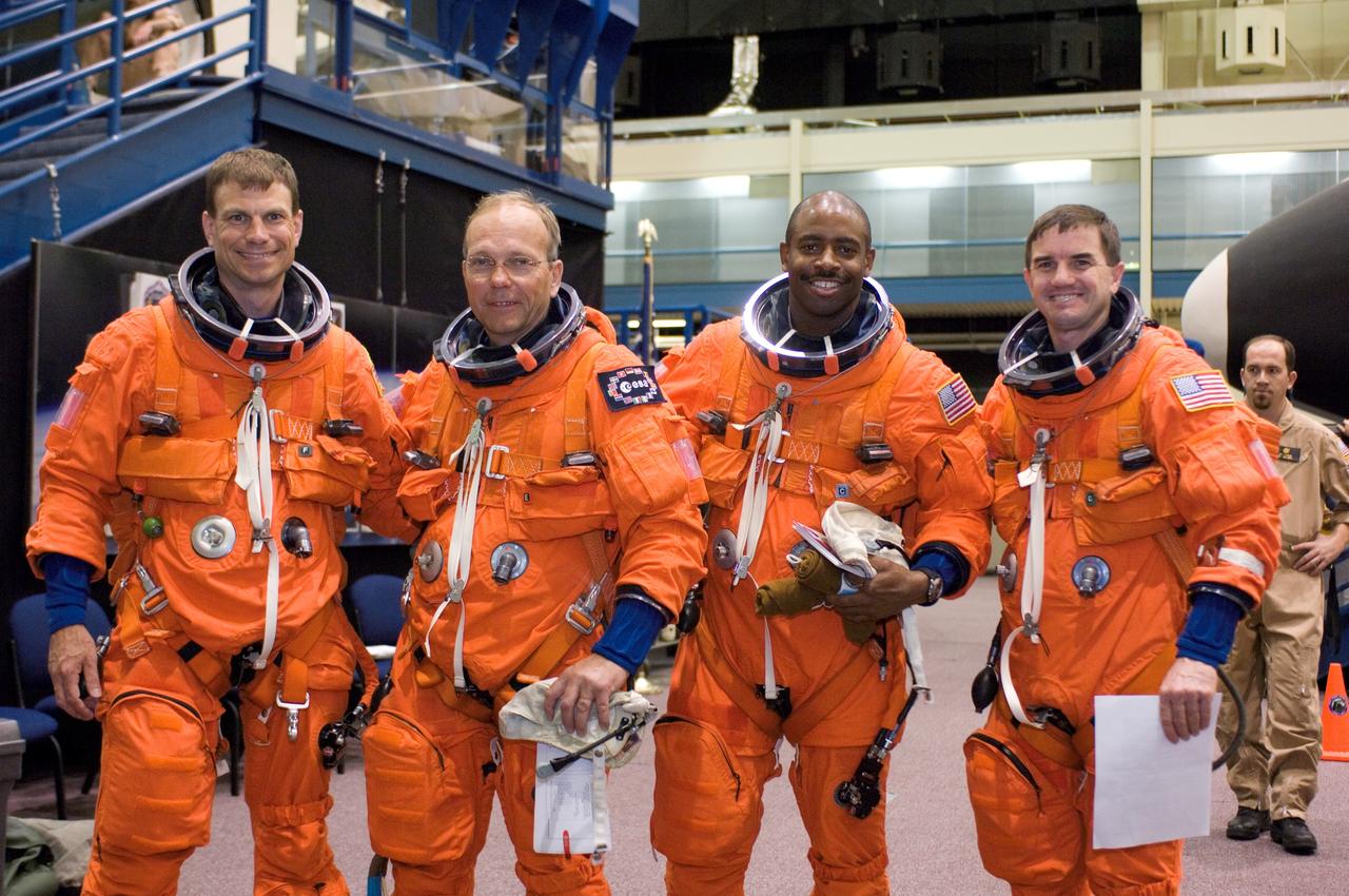 JSC2007-E-14481 (20 March 2007) --- Attired in training versions of their shuttle launch and entry suits, astronauts Stanley G. Love (left), European Space Agency's (ESA) Hans Schlegel, Leland D. Melvin and Rex J. Walheim, all STS-122 mission specialists, take a moment to pose for a photo as they prepare for a post insertion/de-orbit training session in one of the full-scale trainers (out of frame) in the Space Vehicle Mockup Facility at Johnson Space Center.