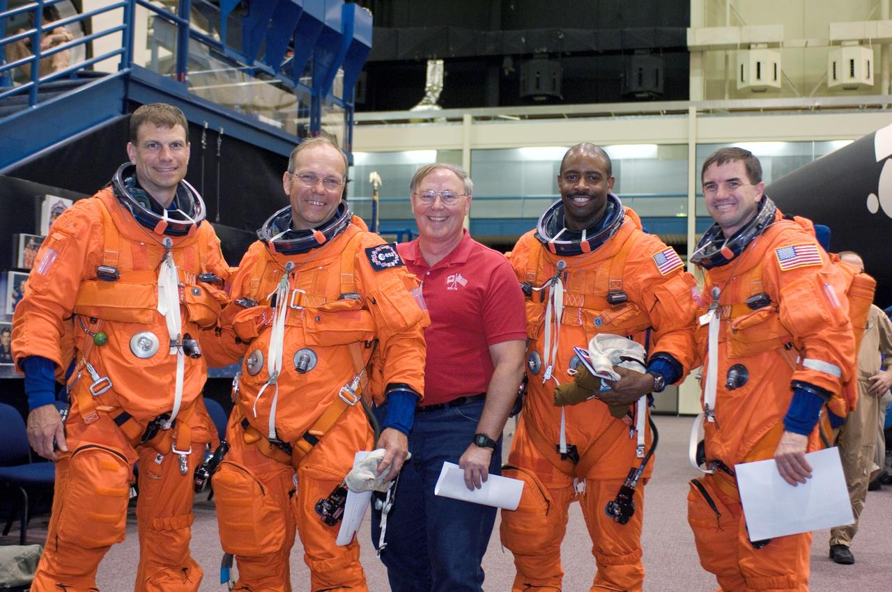 JSC2007-E-14482 (20 March 2007) --- Jerry L. Ross (center), chief, vehicle integration test office, poses for a photo with astronauts Stanley G. Love (left), European Space Agency's (ESA) Hans Schlegel, Leland D. Melvin and Rex J. Walheim, STS-122 mission specialists, as they prepare for a post insertion/de-orbit training session in one of the full-scale trainers (out of frame) in the Space Vehicle Mockup Facility at Johnson Space Center.