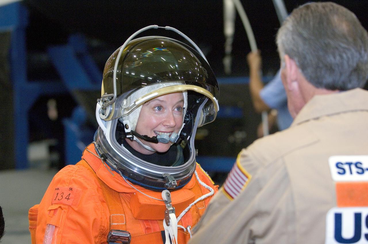 JSC2007-E-18125 (9 April 2007) --- Astronaut Pamela A. Melroy, STS-120 commander, and United Space Alliance crew trainer John Hazelhurst exchange thoughts during a training session in the Space Vehicle Mockup Facility at Johnson Space Center. Melroy is wearing a training version of her shuttle launch and entry suit.