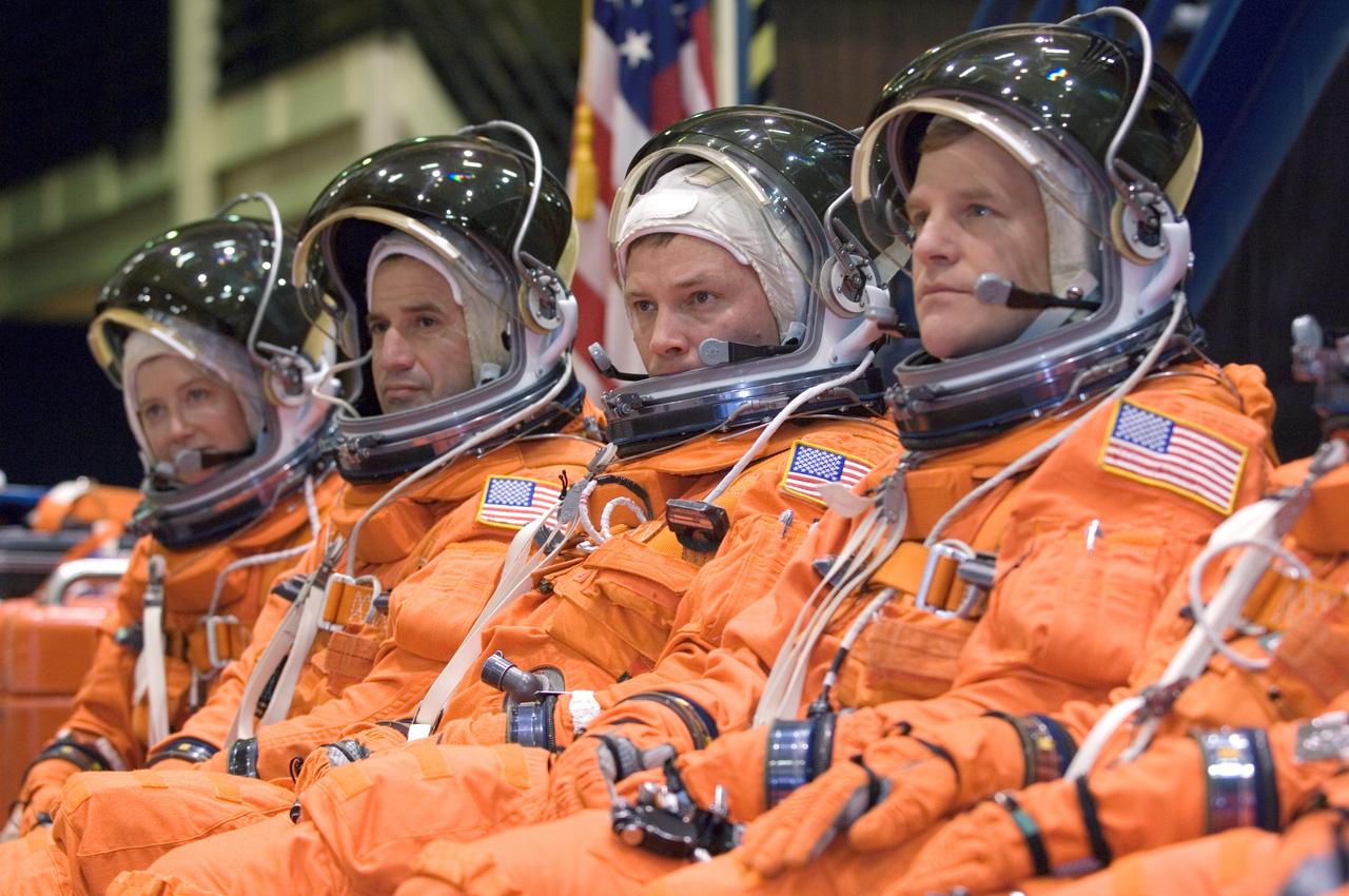JSC2007-E-18132 (9 April 2007) --- Attired in training versions of their shuttle launch and entry suits, astronauts Pamela A. Melroy (left), STS-120 commander; George D. Zamka, pilot; Douglas H. Wheelock and Scott E. Parazynski, both mission specialists, await the start of a training session in the Space Vehicle Mockup Facility at Johnson Space Center.