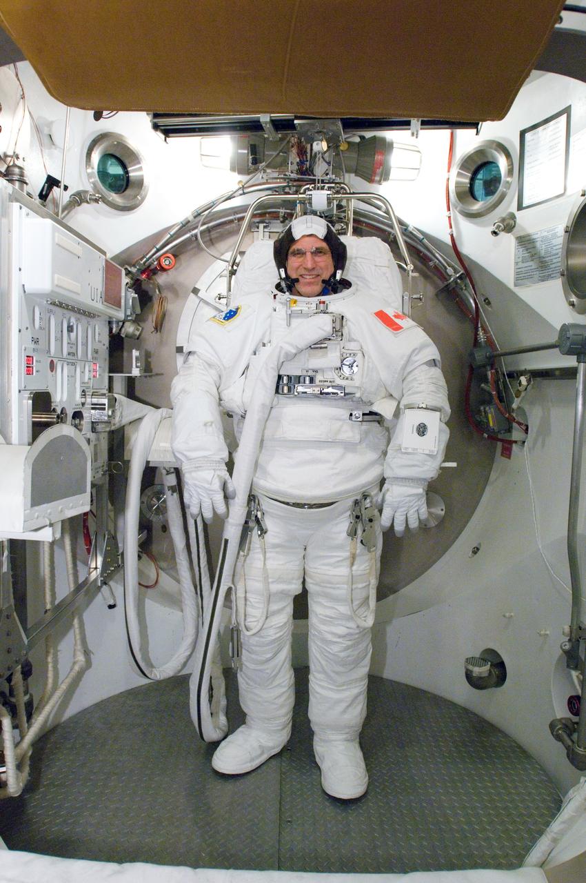 JSC2007-E-18278 (9 April 2007) --- Astronaut Dafydd R. (Dave) Williams, STS-118 mission specialist representing the Canadian Space Agency, participates in an Extravehicular Mobility Unit (EMU) spacesuit fit check in the Space Station Airlock Test Article (SSATA) in the Crew Systems Laboratory at the Johnson Space Center.