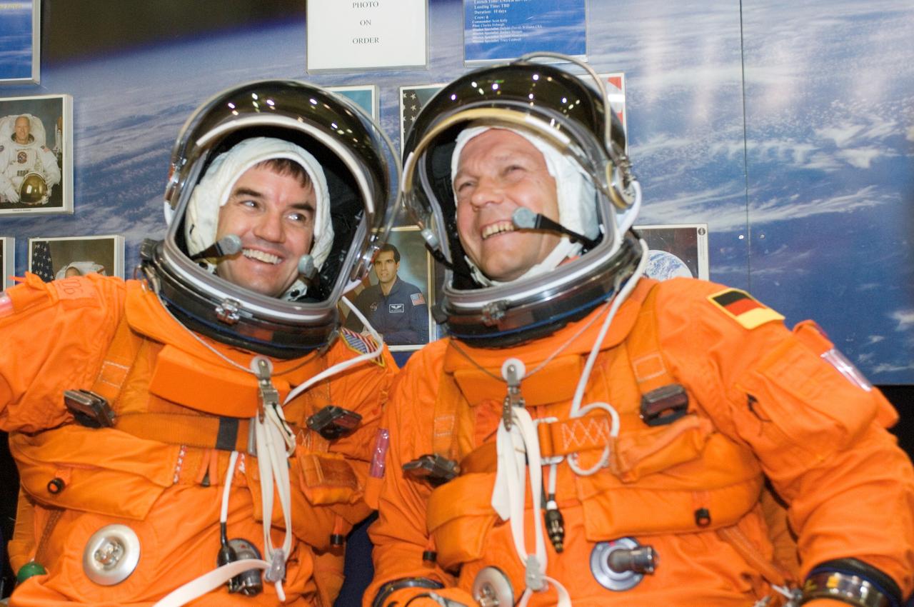 JSC2007-E-21201 (1 May 2007) --- Astronaut Rex J. Walheim (left) and European Space Agency (ESA) astronaut Hans Schlegel, STS-122 mission specialists, enjoy a light moment as they await the start of an emergency egress training session in the Space Vehicle Mockup Facility at Johnson Space Center. Walheim and Schlegel are wearing training versions of their shuttle launch and entry suits.