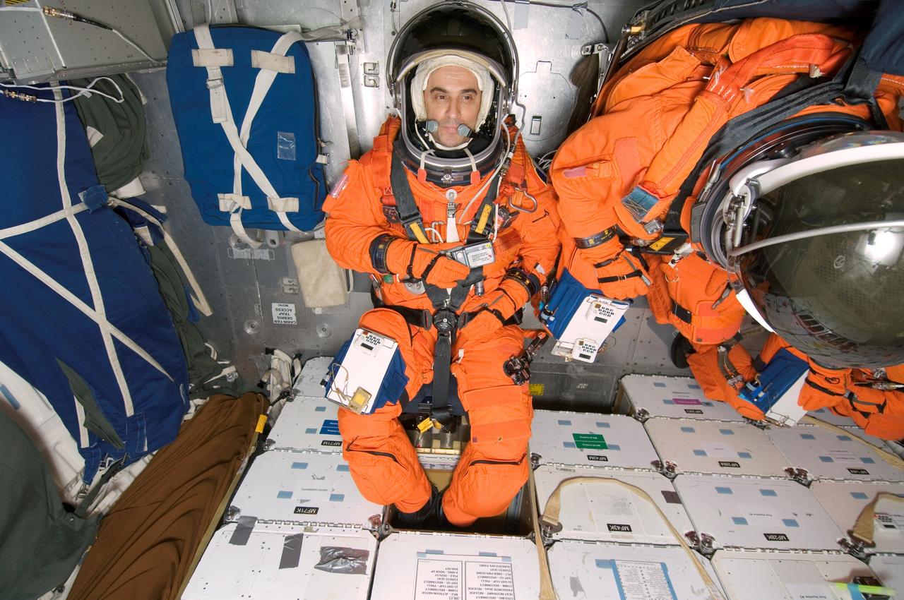 JSC2007-E-21237 (1 May 2007) --- European Space Agency (ESA) astronaut Leopold Eyharts, Expedition 16 flight engineer; astronaut Stanley G. Love (partially out of frame) and ESA astronaut Hans Schlegel (out of frame), both STS-122 mission specialists, participate in a training session in one of the full-scale trainers in the Space Vehicle Mockup Facility at Johnson Space Center. Attired in training versions of their shuttle launch and entry suits, the three are seated on the middeck for a post insertion/de-orbit training session. Eyharts is scheduled to join Expedition 16 as flight engineer after launching to the International Space Station on mission STS-122.