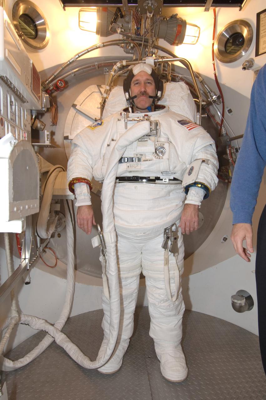 JSC2008-E-006307 (22 Jan. 2008) --- Astronaut John M. Grunsfeld, STS-125 mission specialist, participates in an Extravehicular Mobility Unit (EMU) spacesuit fit check in the Space Station Airlock Test Article (SSATA) in the Crew Systems Laboratory at the Johnson Space Center.
