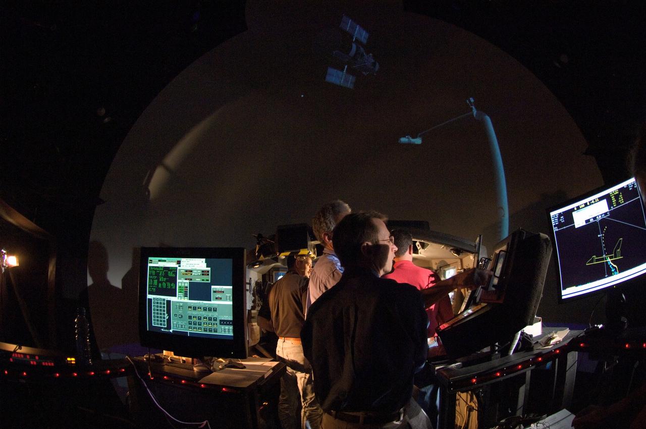JSC2008-E-007759 (28 Jan. 2008) --- STS-125 crewmembers participate in an exercise in the systems engineering simulator in the Avionics Systems Laboratory at Johnson Space Center. The facility includes moving scenes of full-sized Hubble Space Telescope components over a simulated Earth. Pictured are astronauts Andrew J. Feustel (foreground), Michael T. Good, both mission specialists; and Scott D. Altman, commander.