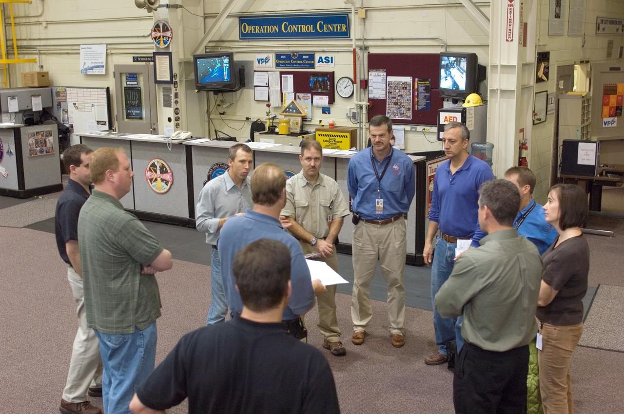 JSC2008-E-008415 (29 Jan. 2008) --- The STS-125 crewmembers participate in a training session in the Space Vehicle Mockup Facility at the Johnson Space Center. Pictured from the right are Michael T. Good, K. Megan McArthur, both mission specialists; Gregory C. Johnson, pilot; Michael J. Massimino, mission specialist; Scott D. Altman, commander; John M. Grunsfeld and Andrew J. Feustel, both mission specialists. United Space Alliance (USA) crew trainer Robert H. (Rob) Tomaro (center, back to camera) briefed the crew.