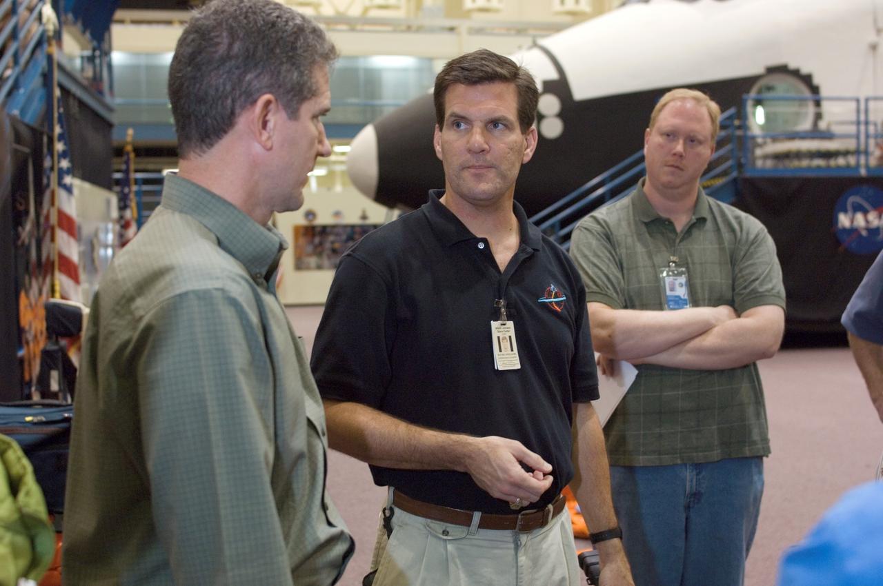 JSC2008-E-008417 (29 Jan. 2008) --- Astronaut Michael T. Good (left), STS-125 mission specialist, participates in a training session in the Space Vehicle Mockup Facility at the Johnson Space Center. United Space Alliance (USA) instructor David L. Williams (center) assisted Good.