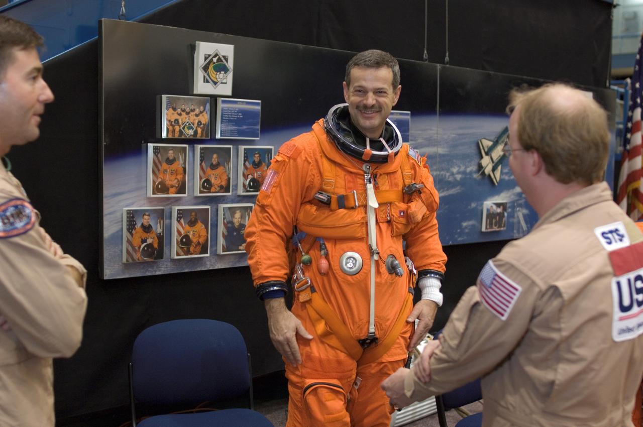 JSC2008-E-008441 (29 Jan. 2008) --- Attired in a training version of his shuttle launch and entry suit, astronaut Scott D. Altman, STS-125 commander, and United Space Alliance (USA) suit technicians Daniel Palmer (right) and Mike Thompson enjoy a light moment as they prepare for a training session in the Space Vehicle Mockup Facility at Johnson Space Center.