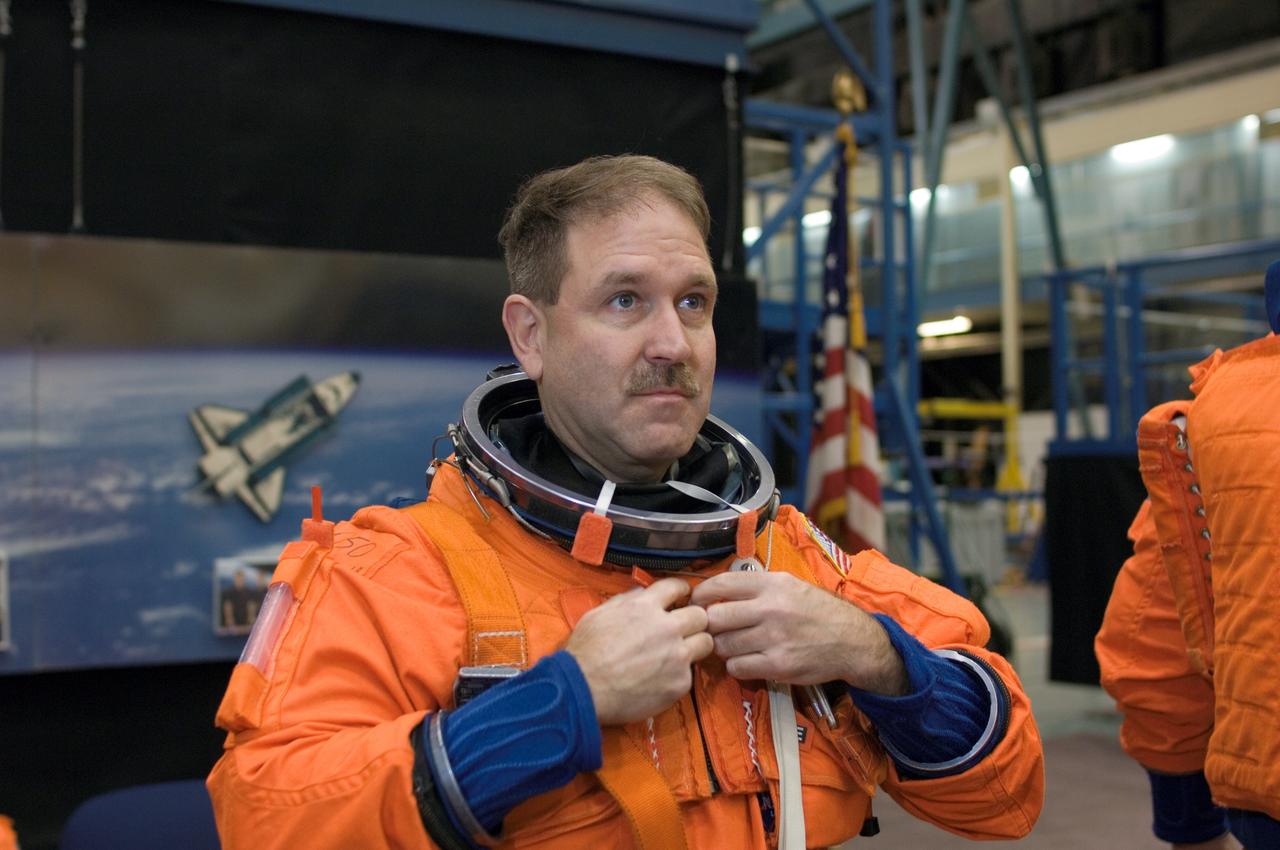 JSC2008-E-008458 (29 Jan. 2008) --- Astronaut John M. Grunsfeld, STS-125 mission specialist, dons a training version of his shuttle launch and entry suit in preparation for a training session in the Space Vehicle Mockup Facility at Johnson Space Center.