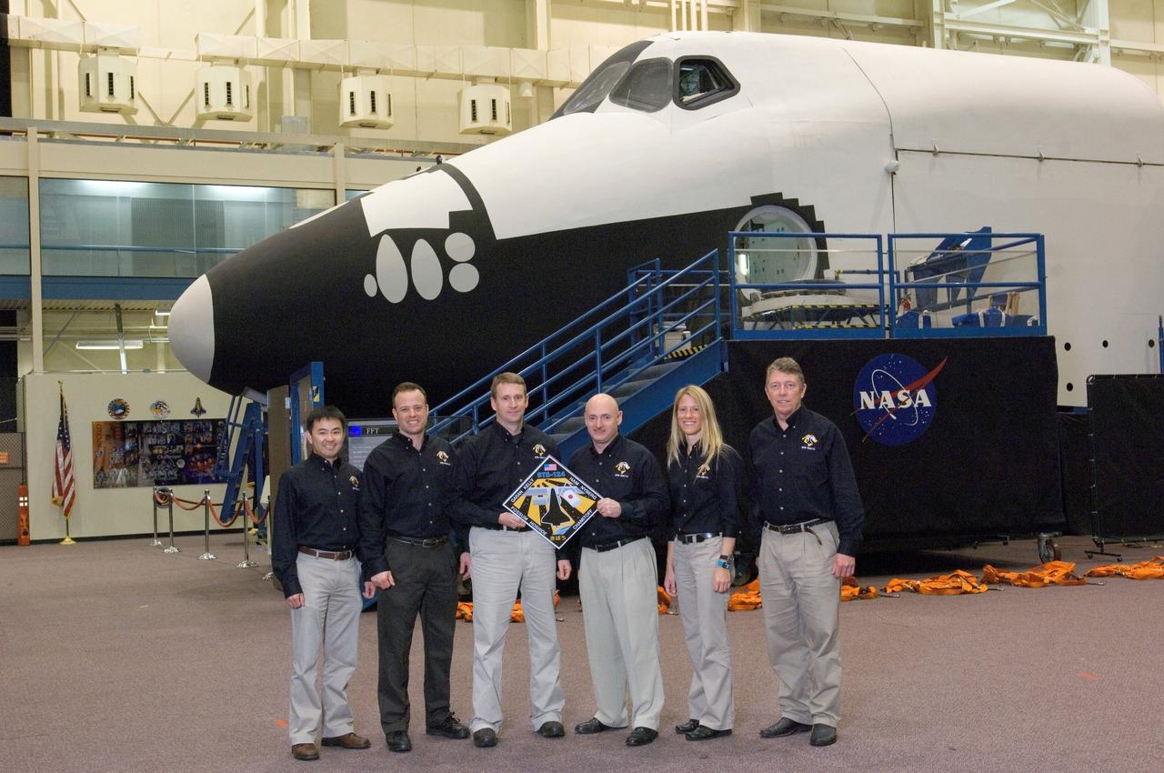 JSC2008-E-009414 (31 Jan. 2008) --- The STS-124 crewmembers take a moment to pose for a portrait during a training session in the Space Vehicle Mockup Facility at the Johnson Space Center. Astronauts Mark E. Kelly (center right) and Kenneth T. Ham, commander and pilot, respectively, hold the STS-124 mission logo. Also pictured (from the left) are Japan Aerospace Exploration Agency (JAXA) astronaut Akihiko Hoshide, NASA astronauts Ronald J. Garan, Karen L. Nyberg and Michael E. Fossum, all mission specialists.