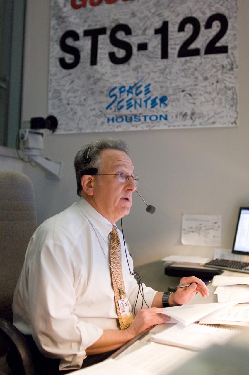 JSC2008-E-010333 (7 Feb. 2008) --- Public Affairs Office commentator Rob Navias watches the large screens in the space shuttle flight control room of Johnson Space Center's Mission Control Center (MCC) during launch countdown activities a few hundred miles away in Florida, site of Space Shuttle Atlantis' scheduled STS-122 launch. Liftoff occurred at 2:45 p.m. (EST) on Feb. 7, 2008 from launch pad 39A at Kennedy Space Center.