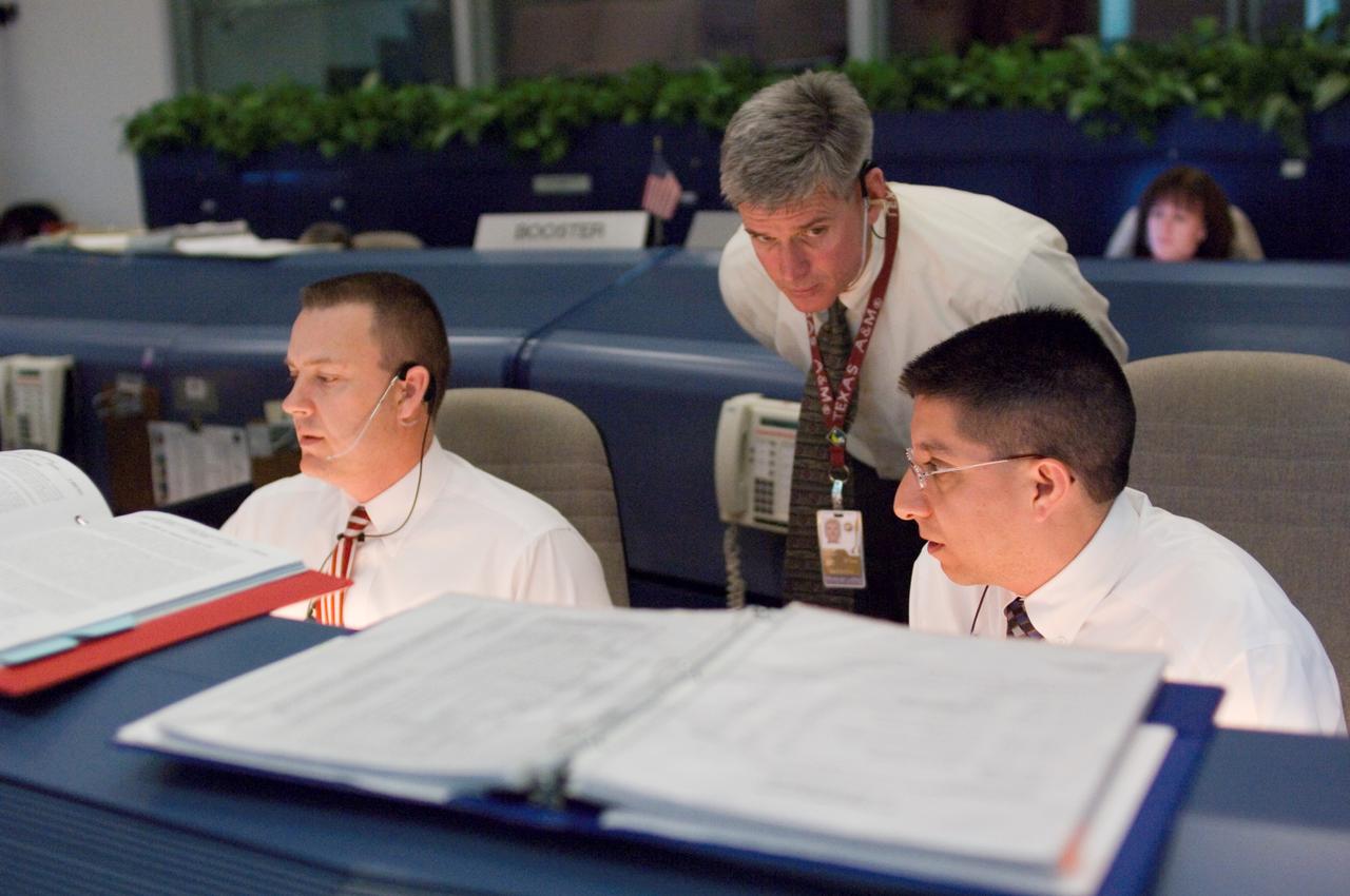 JSC2008-E-010344 (7 Feb. 2008) --- Flight directors Norm Knight (left), Bryan Lunney and Richard Jones monitor data at their consoles in the space shuttle flight control room of Johnson Space Center's Mission Control Center (MCC) during launch countdown activities a few hundred miles away in Florida, site of Space Shuttle Atlantis' scheduled STS-122 launch. Liftoff occurred at 2:45 p.m. (EST) on Feb. 7, 2008 from launch pad 39A at Kennedy Space Center.