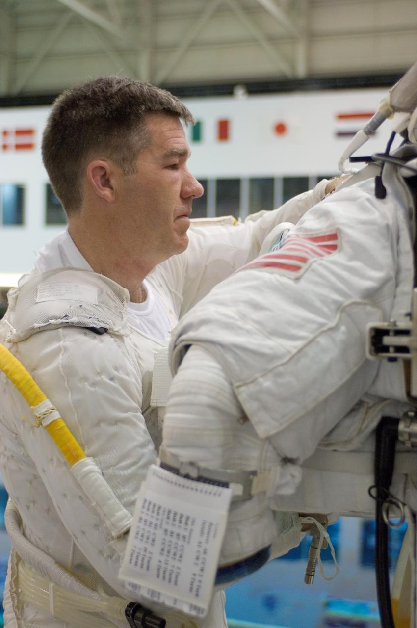 JSC2008-E-015704 (26 Feb. 2008) --- Astronaut Stephen G. Bowen, STS-126 mission specialist, works with a training version of the Extravehicular Mobility Unit (EMU) spacesuit in preparation for a training session in the waters of the Neutral Buoyancy Laboratory (NBL) near Johnson Space Center.
