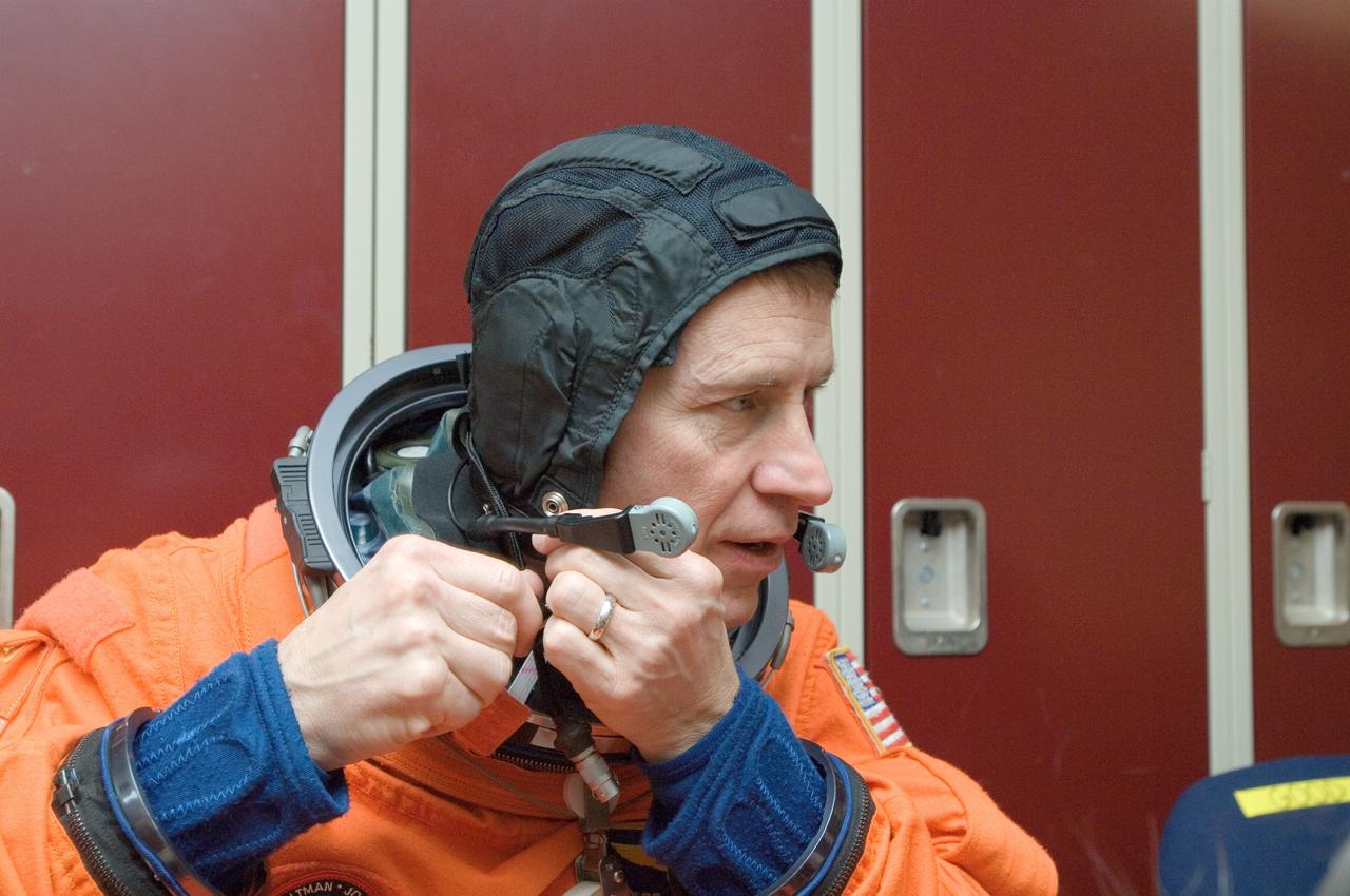 JSC2008-E-018325 (27 Feb. 2008) --- Astronaut Gregory C. Johnson, STS-125 pilot, dons a training version of his shuttle launch and entry suit in preparation for a training session in the Space Vehicle Mockup Facility at Johnson Space Center.