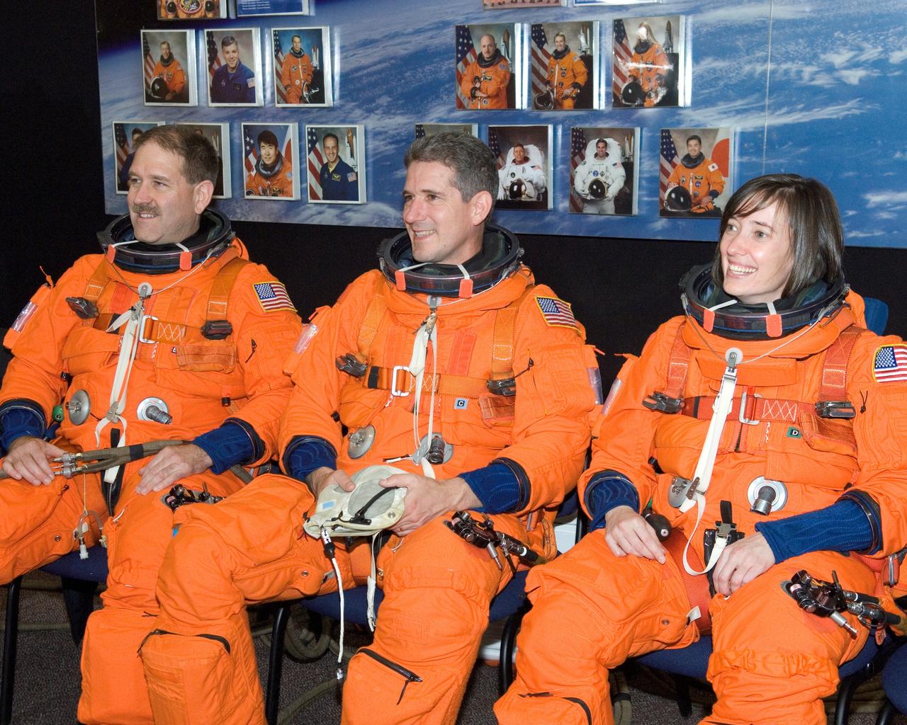 JSC2008-E-018350 (27 Feb. 2008) --- Astronauts John M. Grunsfeld (left), Michael T. Good and K. Megan McArthur, all STS-125 mission specialists, await the start of a training session in the Space Vehicle Mockup Facility at Johnson Space Center. The crewmembers are attired in training versions of their shuttle launch and entry suits.