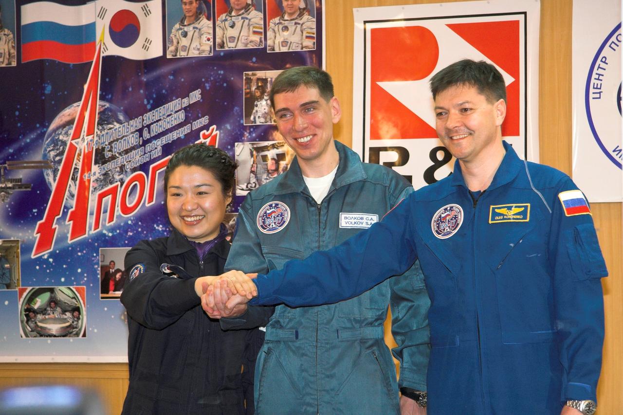 JSC2008-E-032248 (7 April 2008) --- At their crew quarters in Baikonur, Kazakhstan, Expedition 17 Commander Sergei Volkov (center), Flight Engineer Oleg Kononenko (right) and South Korean spaceflight participant So-yeon Yi clasp hands for photographers on April 7, 2008, the eve of their launch to the International Space Station. Volkov, Kononenko and Yi are scheduled to launch to the station on the Soyuz TMA-12 spacecraft from the Baikonur Cosmodrome on April 8 and arrive at the ISS on April 10 to begin what will be six months in space for Volkov and Kononenko. Yi will be in space nine days on the complex, returning to Earth with two of the Expedition 16 crewmembers currently on the station. Photo Credit: NASA /Victor Zelentsov