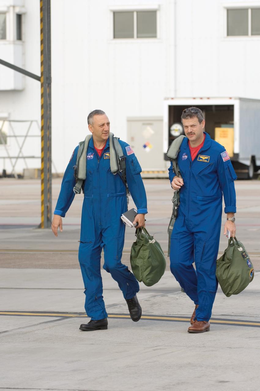 JSC2008-E-035358 (17 April 2008) --- Astronauts Scott D. Altman (right) and Michael J. Massimino, STS-125 commander and mission specialist, respectively, walk to the nearby flight line of NASA T-38 trainer jets at Ellington Field near NASA's Johnson Space Center.