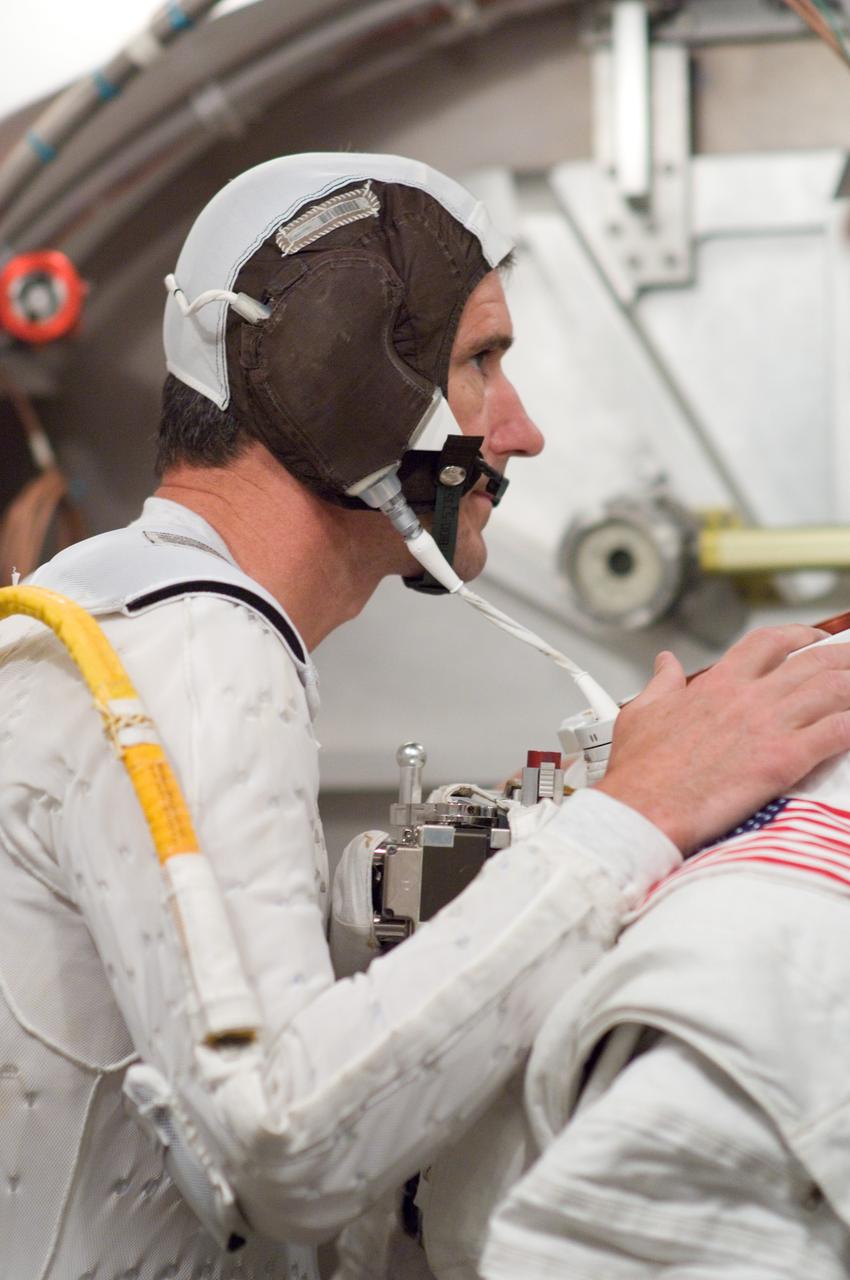 JSC2008-E-035884 (22 April 2008) --- Astronaut Michael T. Good, STS-125 mission specialist, participates in an Extravehicular Mobility Unit (EMU) spacesuit fit check in the Space Station Airlock Test Article (SSATA) in the Crew Systems Laboratory at NASA's Johnson Space Center.