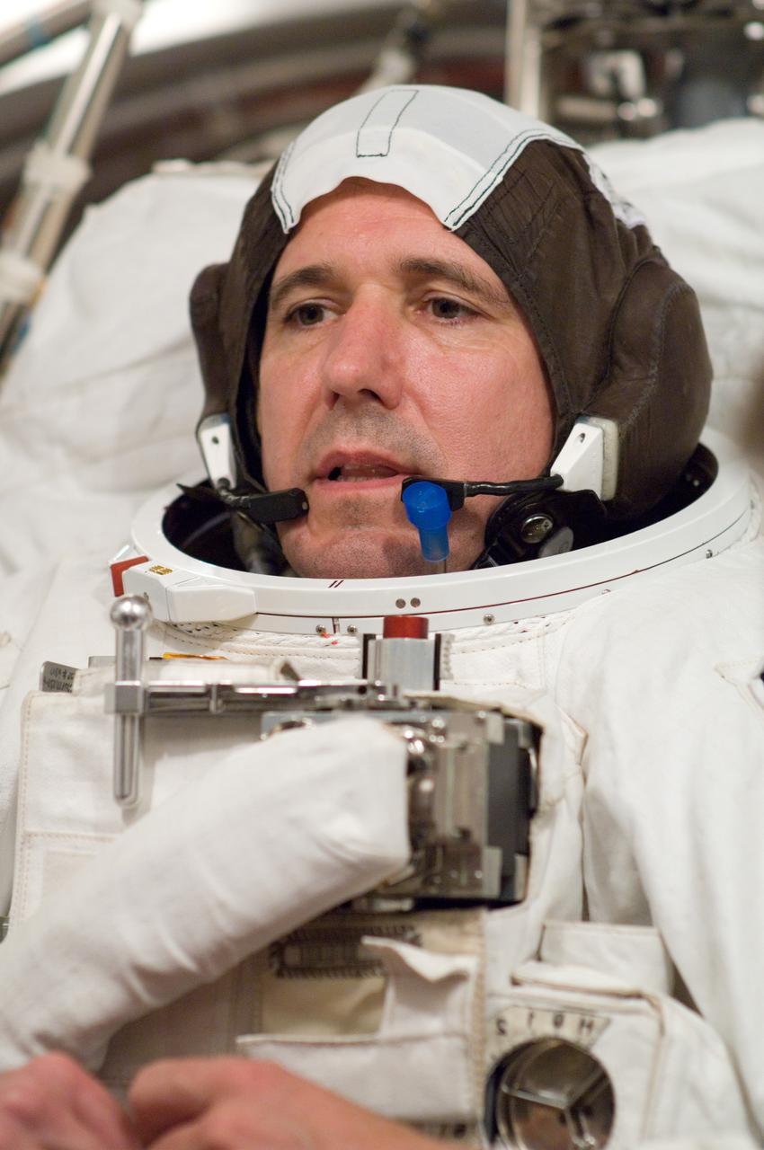 JSC2008-E-035888 (22 April 2008) --- Astronaut Michael T. Good, STS-125 mission specialist, participates in an Extravehicular Mobility Unit (EMU) spacesuit fit check in the Space Station Airlock Test Article (SSATA) in the Crew Systems Laboratory at NASA's Johnson Space Center.