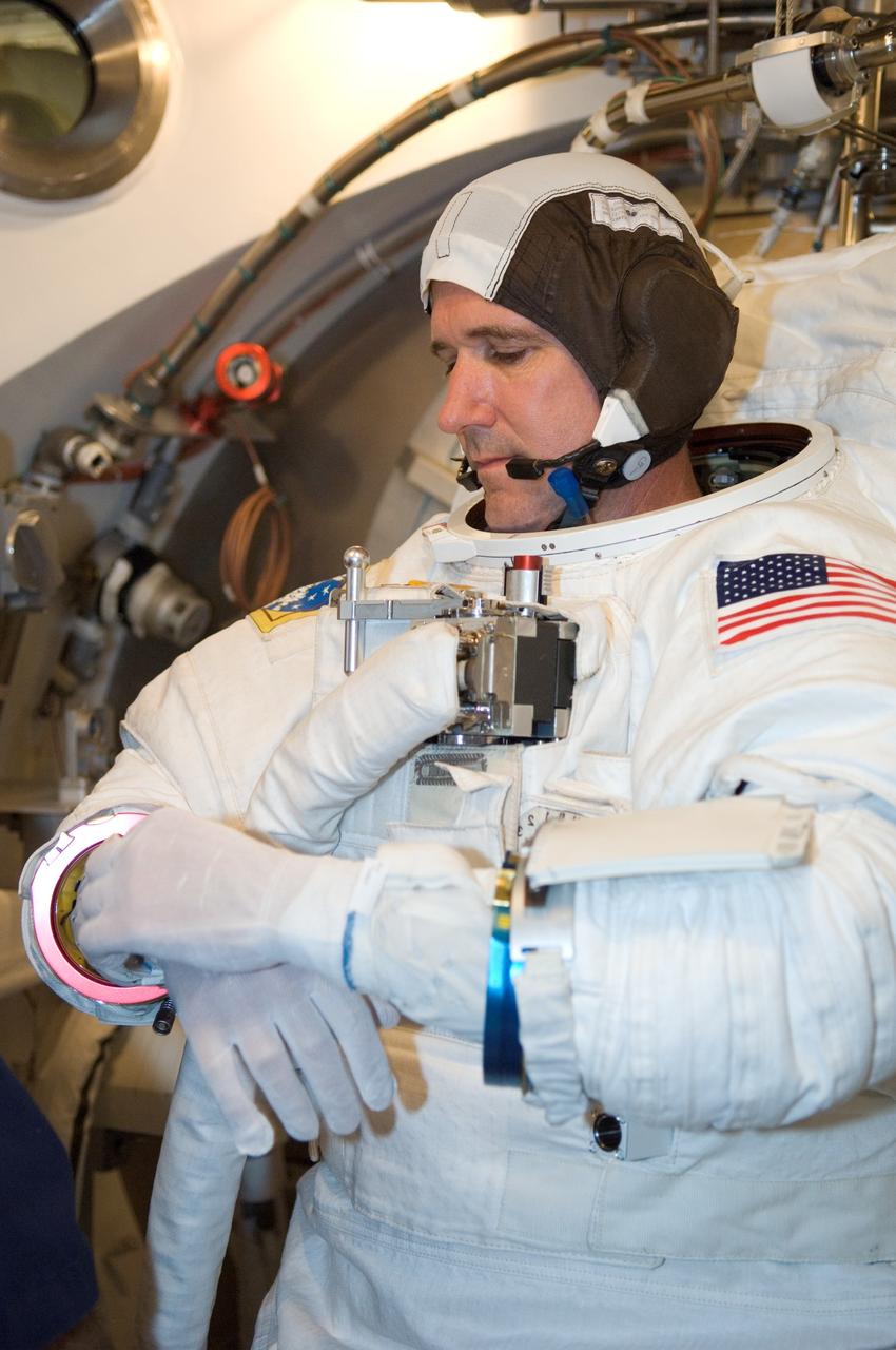 JSC2008-E-035889 (22 April 2008) --- Astronaut Michael T. Good, STS-125 mission specialist, participates in an Extravehicular Mobility Unit (EMU) spacesuit fit check in the Space Station Airlock Test Article (SSATA) in the Crew Systems Laboratory at NASA's Johnson Space Center.